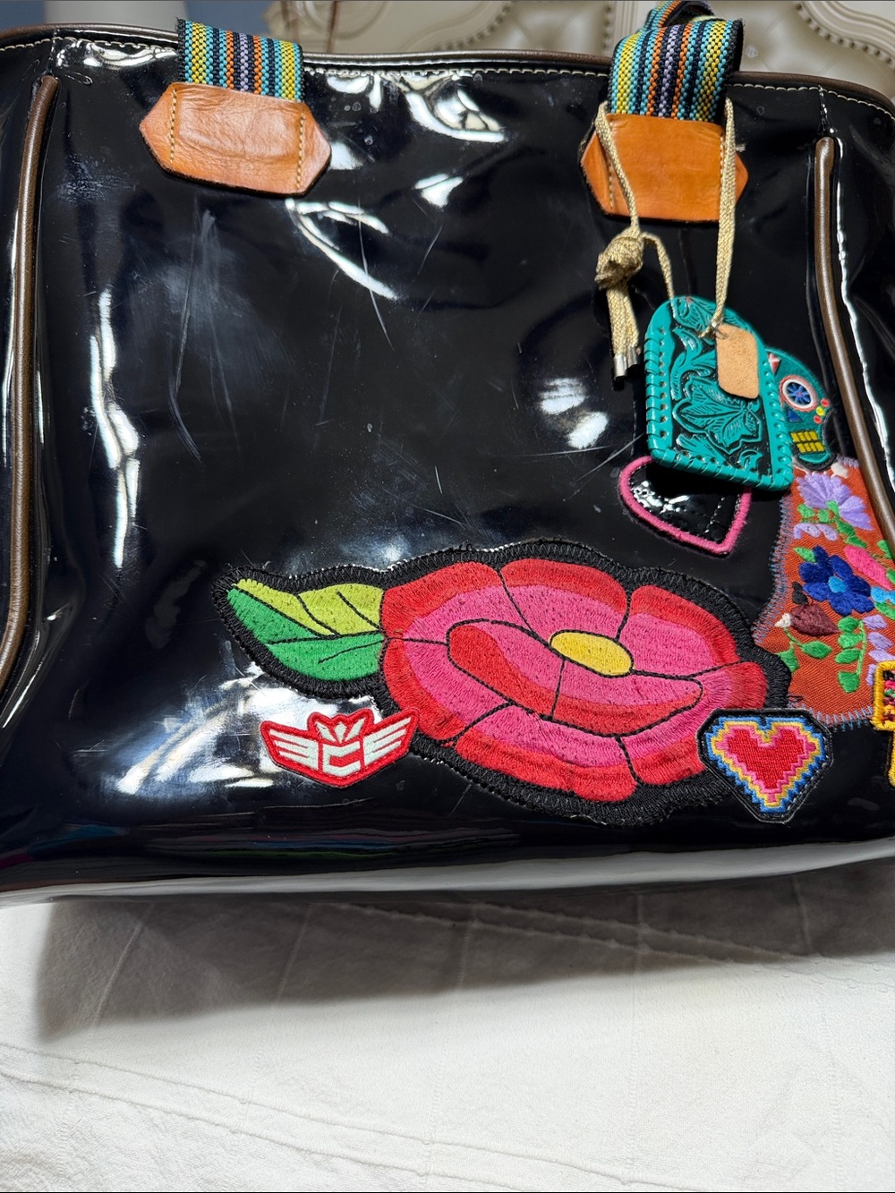 Consuela Black Patent Tote with Colorful Floral Patches and Striped Handles